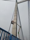 Repairing work going on the vidyasagar setu or second hooghly bridge by mechanical ladder with two expert's