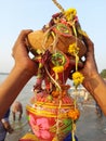 A devotee holding a decorated pot with ganges water after immersion of ma kali as a ritual. Royalty Free Stock Photo