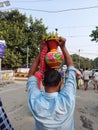 A divotee  with a  decorated ghot  on the head filled with Ganges water after immersion  of ma kali. Royalty Free Stock Photo
