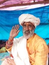 Sadhu sited on the transit camp at bank of the river Ganges prior to Gangasagar yatra with a blessing hand