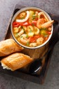 Caldeirada Portuguese seafood Stew with shrimps, mussels and squid closeup in the bowl. Vertical top view