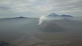 Caldera Bromo in the morning. Cloeds over volcano and smoke from crater. Timelapse Mountain Clouds