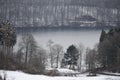 caldera lake Pulvermaar near Gillenfeld with light snow aound