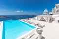 caldera and luxury hotel endless swimming pool, canopy blue sea view. Luxurious travel and vacation landscape, white architecture Royalty Free Stock Photo