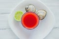 Caldo de almeja, consome de almejas, cocktail with lemon and salted cookies mexican sea food in mexico