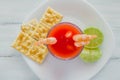 Caldo de camaron, consome de camarones, Shrimp cocktail with lemon and salted cookies mexican sea food in mexico