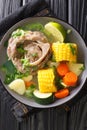 Caldo de Res is a Mexican beef soup with lots of vegetables such as squash, corn, carrots, cabbage and potatoes closeup on the Royalty Free Stock Photo