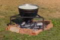 Caldron with boiling milk for cooking Adyghe cheese on fire