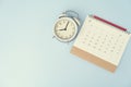 Calendar, alarm clock and pencil on the blue table background, planning for business meeting or travel planning Royalty Free Stock Photo