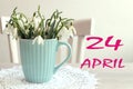 Calendar for April 24: the name of the month April in English, the numbers 24, a bouquet of snowdrops on the background of a