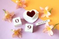 Calendar for August 9 :the name of the month of August in English, cubes with the number 09, a cup of tea in the shape of a heart Royalty Free Stock Photo