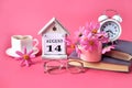 Calendar for August 14 : the name of the month of August in English, the number 14, a cup of tea, books, a bouquet of pink flowers Royalty Free Stock Photo