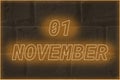 Calendar date on the background of an old brick wall. 1 november written glowing font. The concept of an important date or