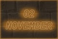 Calendar date on the background of an old brick wall. 2 november written glowing font. The concept of an important date or