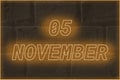Calendar date on the background of an old brick wall. 5 november written glowing font. The concept of an important date or