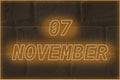 Calendar date on the background of an old brick wall. 7 november written glowing font. The concept of an important date or