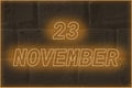 Calendar date on the background of an old brick wall. 23 november written glowing font. The concept of an important date or