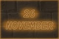 Calendar date on the background of an old brick wall. 26 november written glowing font. The concept of an important date or