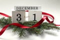 Calendar for December 31 : cubes with the numbers 3 and 1 on spruce branches, the name of the month