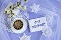 Calendar for December 11: a cup of tea with a decorative snowflake on a lace napkin, the name of the month December in English,