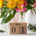 Calendar the first of March on the background of a bouquet of alstroemeria flowers. Concept of the beginning of spring. Royalty Free Stock Photo