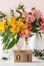 Calendar the first of March on the background of a bouquet of alstroemeria flowers. Concept of the beginning of spring. Royalty Free Stock Photo