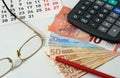 Calendar, glasses, red pencil, euros and calculator