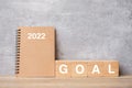 2022 calendar with GOAL block on wood table. Happy New Year, motivation, Resolution, To do list, start, Strategy and Plan concept