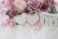 January 14th. Wood cube calendar with date of month and day, pink flowers bouquet and two hearts. Royalty Free Stock Photo