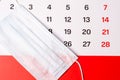The calendar has a medical mask and a red stripe on the bottom