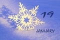 Calendar for January 19: decorative snowflake on the snow close up, numbers 19, name of the month January in English