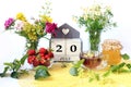 Calendar for July 20 : the name of the month of July in English, cubes with the number 20, bouquets of wild flowers, jam, fruit, a
