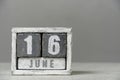 Calendar for June 16, made wooden cubes, on gray background.With an empty space for your text. Royalty Free Stock Photo