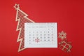 Calendar with marked Boxing Day date and Christmas decorations on red background, flat lay Royalty Free Stock Photo