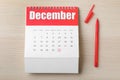 Calendar with marked date and pen on wooden table, flat lay. New Year countdown Royalty Free Stock Photo