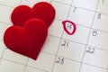 Calendar with marked 14th february date and red heart shaped chocolate candies Royalty Free Stock Photo
