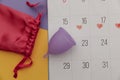Calendar and menstrual cup with bag. Woman critical days and hygiene protection