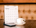 Calendar, mobile, coffee cup Placed on an old wooden table is a planning idea for success Royalty Free Stock Photo
