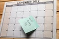 Calendar with a note lies on a wooden table Royalty Free Stock Photo