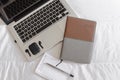 2020 calendar notebook along with a laptop, black wireless earbuds and notebook with pen