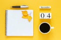 Calendar November 04 cup of coffee, notepad with pen and yellow leaf on yellow background