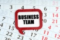 On the calendar, a red plaque with the words inside - Business team