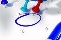 Calendar with red, teal, blue pins and empty cirlced space to remind for something important. Royalty Free Stock Photo