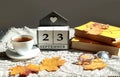 Calendar for September 23 : the name of the month in English, cubes with the number 23, a cup of tea, books, maple leaves on a