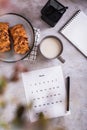 Calendar sheet for planning with a cup of coffee and buns in fika time top and vertical view Royalty Free Stock Photo