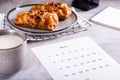 Calendar sheet for planning during a snack with latte and buns in fika time Royalty Free Stock Photo