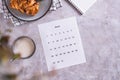 Calendar sheet for planning during a snack with latte and buns in fika time top view Royalty Free Stock Photo