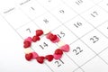 Calendar showing february 14th, valentine`s day rounded with hearts