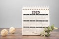 Calendar Year 2025 schedule. 2025 desk calendar notepad on wooden table and gray background. New Year. plans for 2025. gray