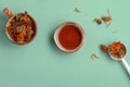 Calendula dried herbs in orange craft cup with honey on blue background. Royalty Free Stock Photo